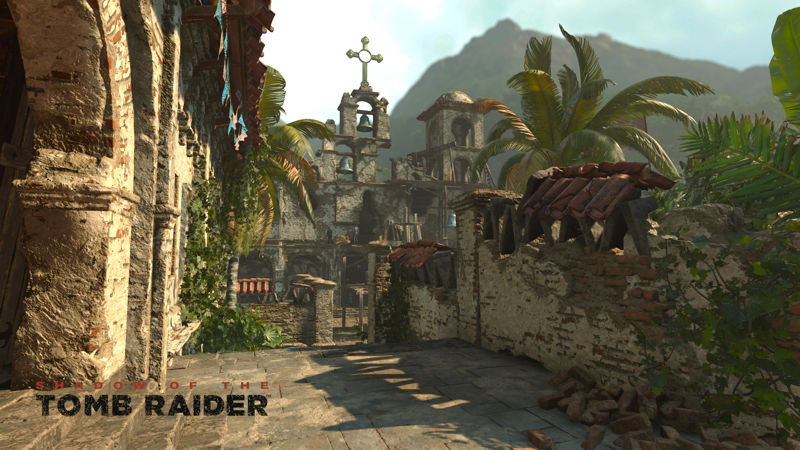 Image shows a pathway to  an open courtyard in a mountain village.